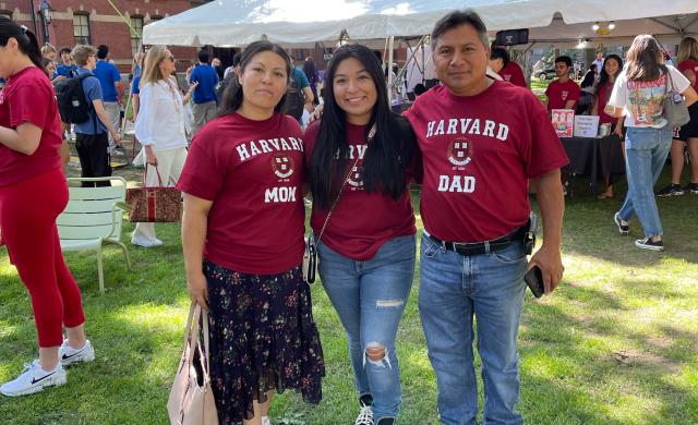 Three people smiling at the camera. 