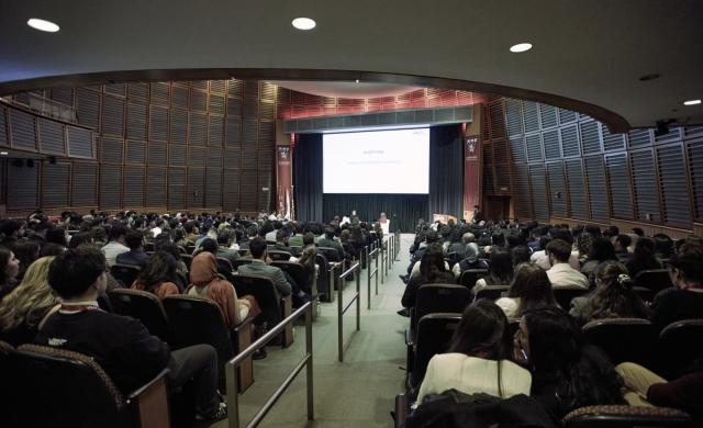 Large auditorium at the Arab Conference at Harvard 2025 with speakers and an audience.
