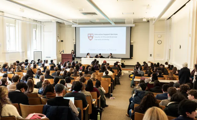 Students seated in large full lecture hall 
