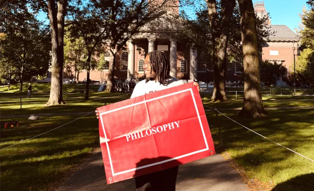 Me standing with my Philosophy banner on Concentration Declaration Day 