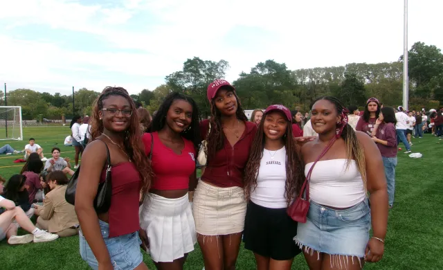A picture of myself and my friends at the Harvard vs. Brown football game. Each person is wearing a variation of Harvard merchandise and crimson