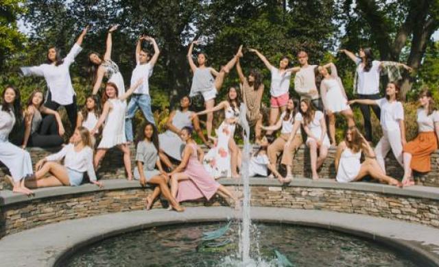 students dancing and posing on a bridge