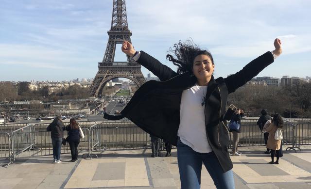 student jumping in front of the Eiffel Tower