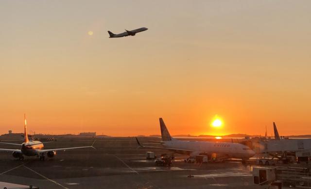 Image of plan taking off during the sunrise. 