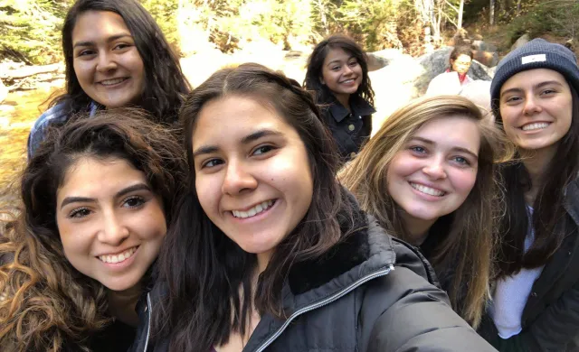 A picture of author with other LU board members near a hiking trail