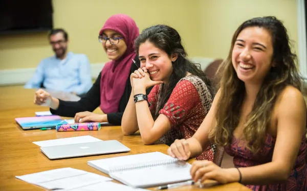 Three female students participating in a small class