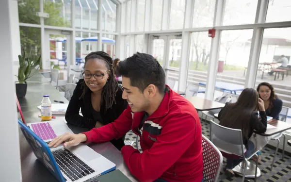 Two students looking at a computer screen