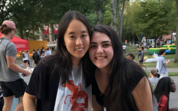 two students eating lobster in Harvard Yard