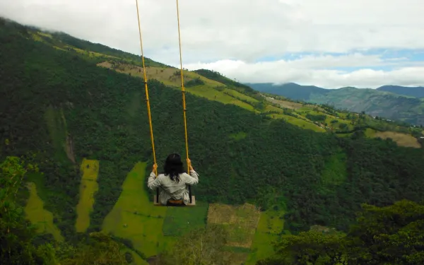 A girl sits on a swing in Ecuador