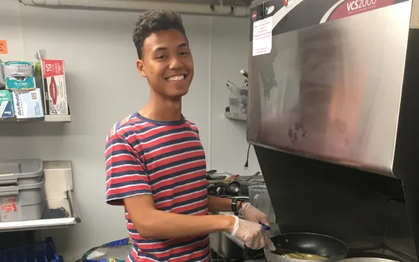 Student cooking in kitchen
