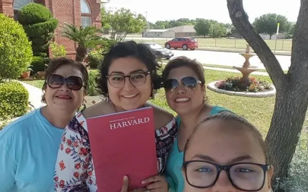 My family and I showing off my Harvard admitted student packet