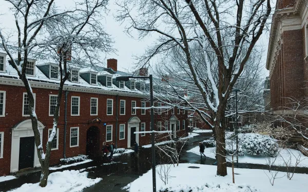 Snow falling outside brick dorm building