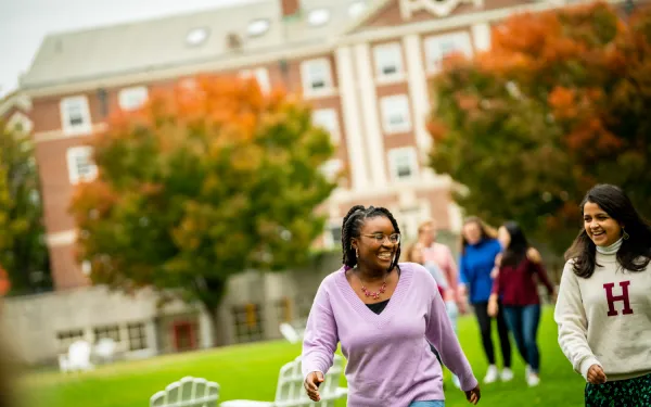 Two female students walking through the Radcliffe Quad