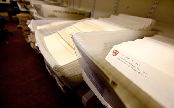 Dozens of admissions packets in mailing bins