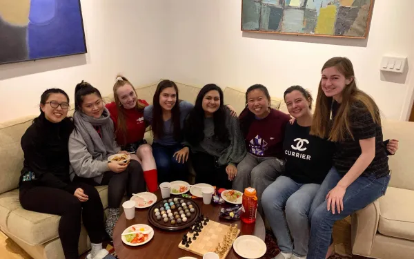 Maria posing with her friend group in Currier House, one of the upperclassmen dorms.