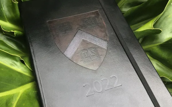 Black journal with Harvard logo and 2022 imprinted on the front
