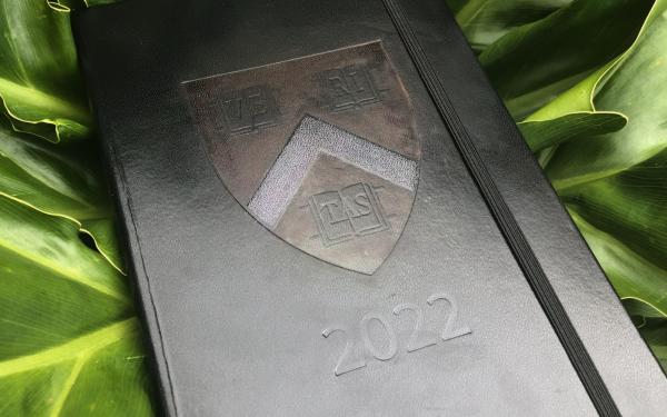 Black journal with Harvard logo and 2022 imprinted on the front