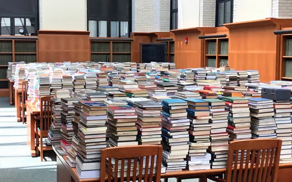 Returns were temporarily stored in the West Stacks Reading Room in Widener Library as they awaited processing by library staff.