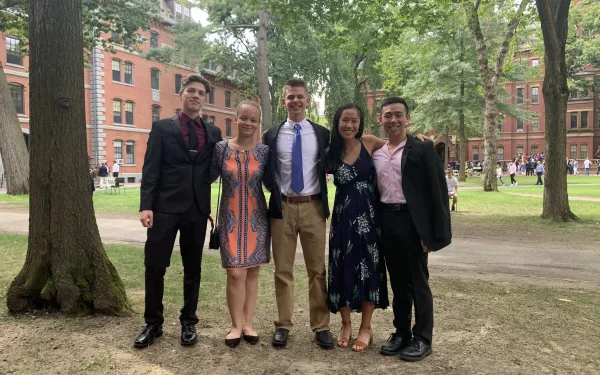 Five Harvard students posing in the Yard at Convocation