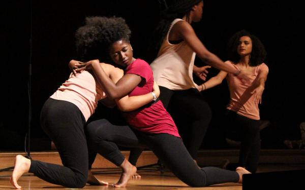 This image shows 4 dancers embracing each other at last year's Kuumba Winter Concert.