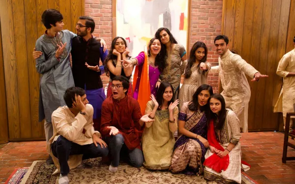 Group of students wearing Indian clothes indoors posing and smiling