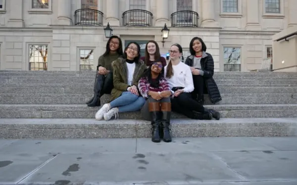 6 ladies sitting on the steps outside of Winthrop House