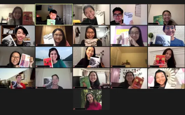 Group of students on Zoom holding up books