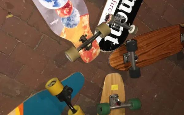 A collection of skateboards all placed near each other.