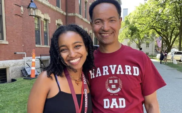 Student poses with father during move-in