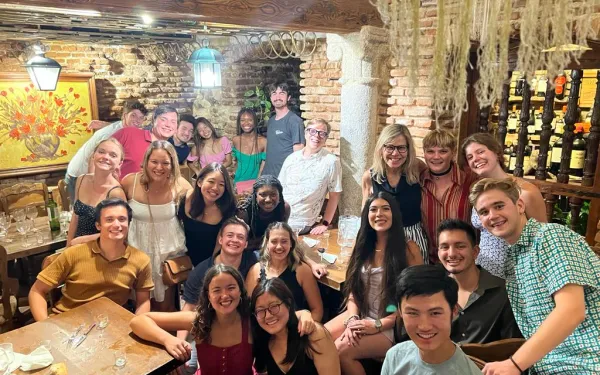 Group picture of students and professors at final dinner celebration 