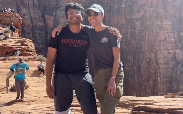 An image of Rafid standing next to FOP director Lesedi Graveline in front of the canyons of Zion National Park, both of them smiling