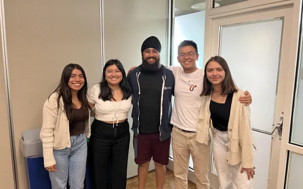 A group of students hugging each other.
