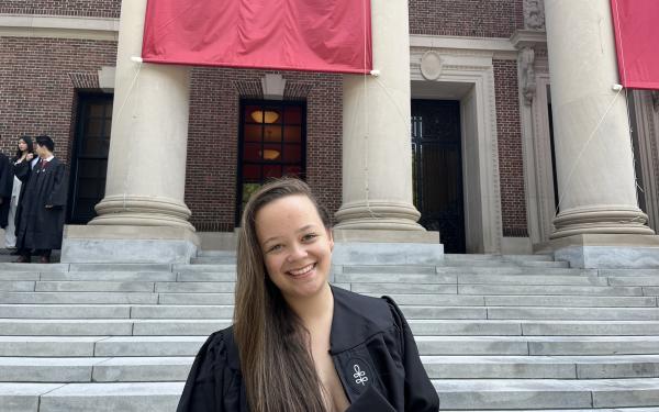 masters with thesis or without Harvard graduate Perrin Price standing on Widener Library steps.