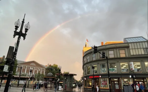 Rainbow at dusk over the Harvard MBTA subway station right after a rainstorm.