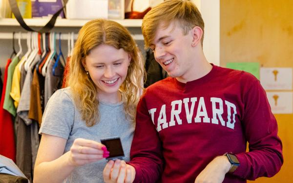 Two students looking at a picture together