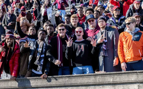 Large crowd of students cheering in the stadium seats