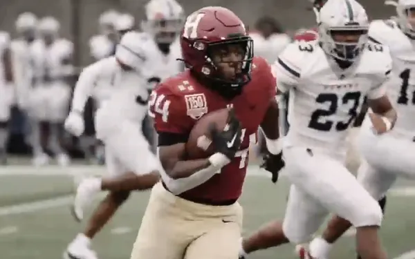 A football player running down the field. 