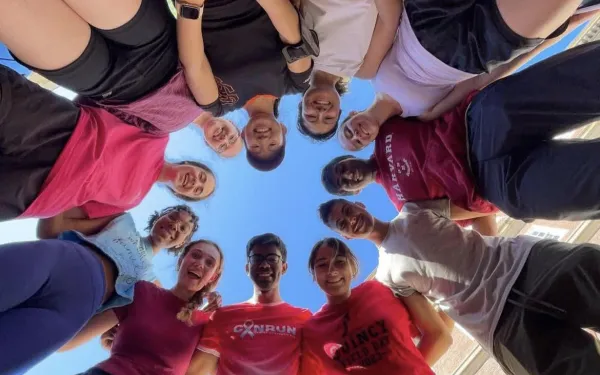 A group of runners looking down at a camera.