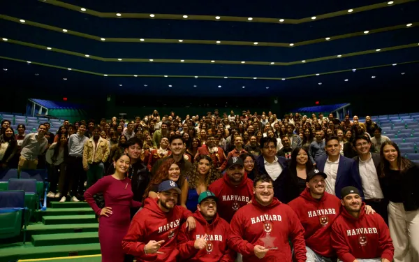 Grupo Frontera band members with the event's guests. People are smiling and happily posing for the picture.  