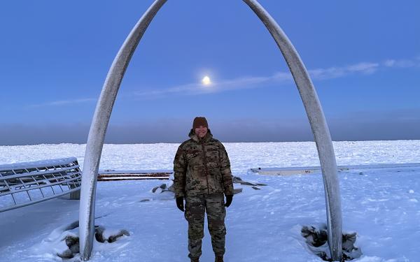 Courtney under and arch in Alaska