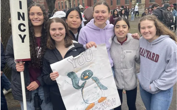Blocking group posed with Quincy signs 