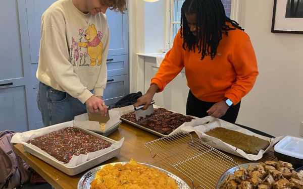 My coworker and I cutting treats to be served at Lowell Tea.