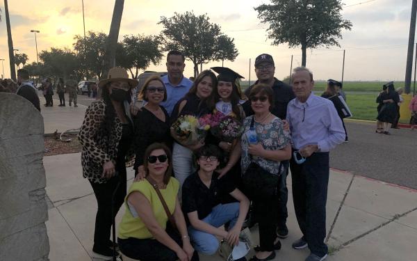 Ana with her family member at her high school graduation.