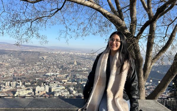 Lizbeth pictured with a view from the top of Tbilisi behind her. 