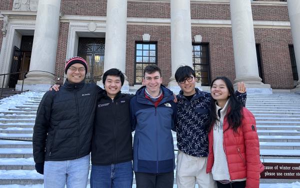 Picture of Raymond and his blocking mates standing in front of the steps of Widener Gate.