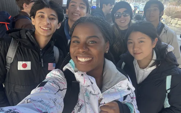Group of students take a selfie in ski gear.
