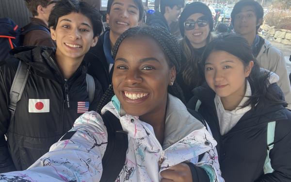 Group of students take a selfie in ski gear.
