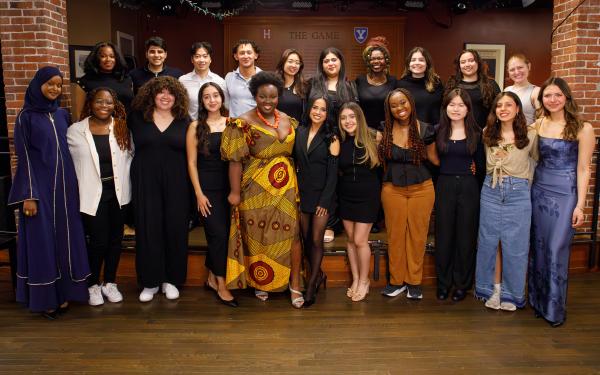 This is a picture of a group of students standing and posing for a picture with Becky G in the middle