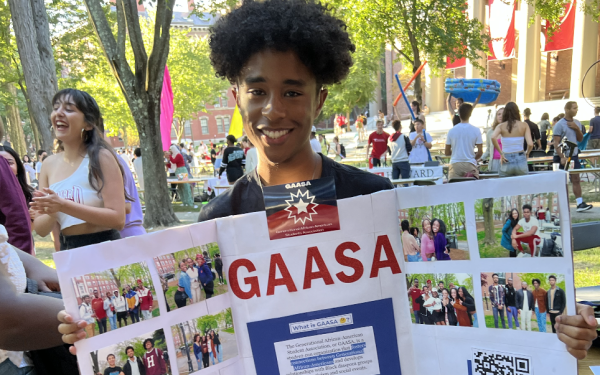 Ricardo holding up a poster board during the student activites fair