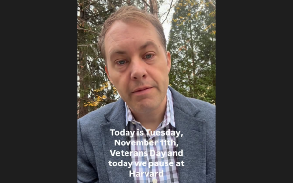 Man outdoors with text about Veterans Day at Harvard.
